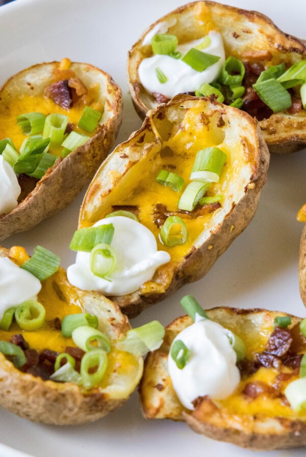 close up air fryer potato skins on a plate with sour cream