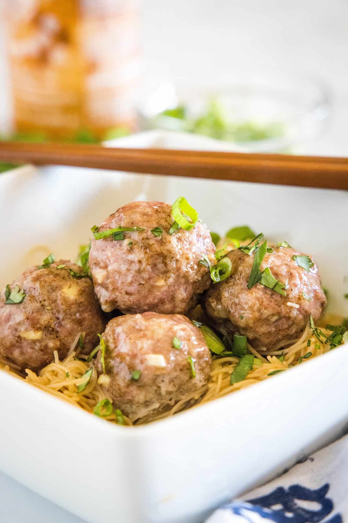 Asian Meatballs with Spicy Rice Noodles | Dinners, Dishes, and Desserts asian meatballs over rice noodles in a bowl