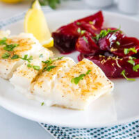 Easy Baked Cod - an easy oven baked cod recipe that is lightly seasoned and topped with melted butter! Served with Harvard Beets for a delicious meal.