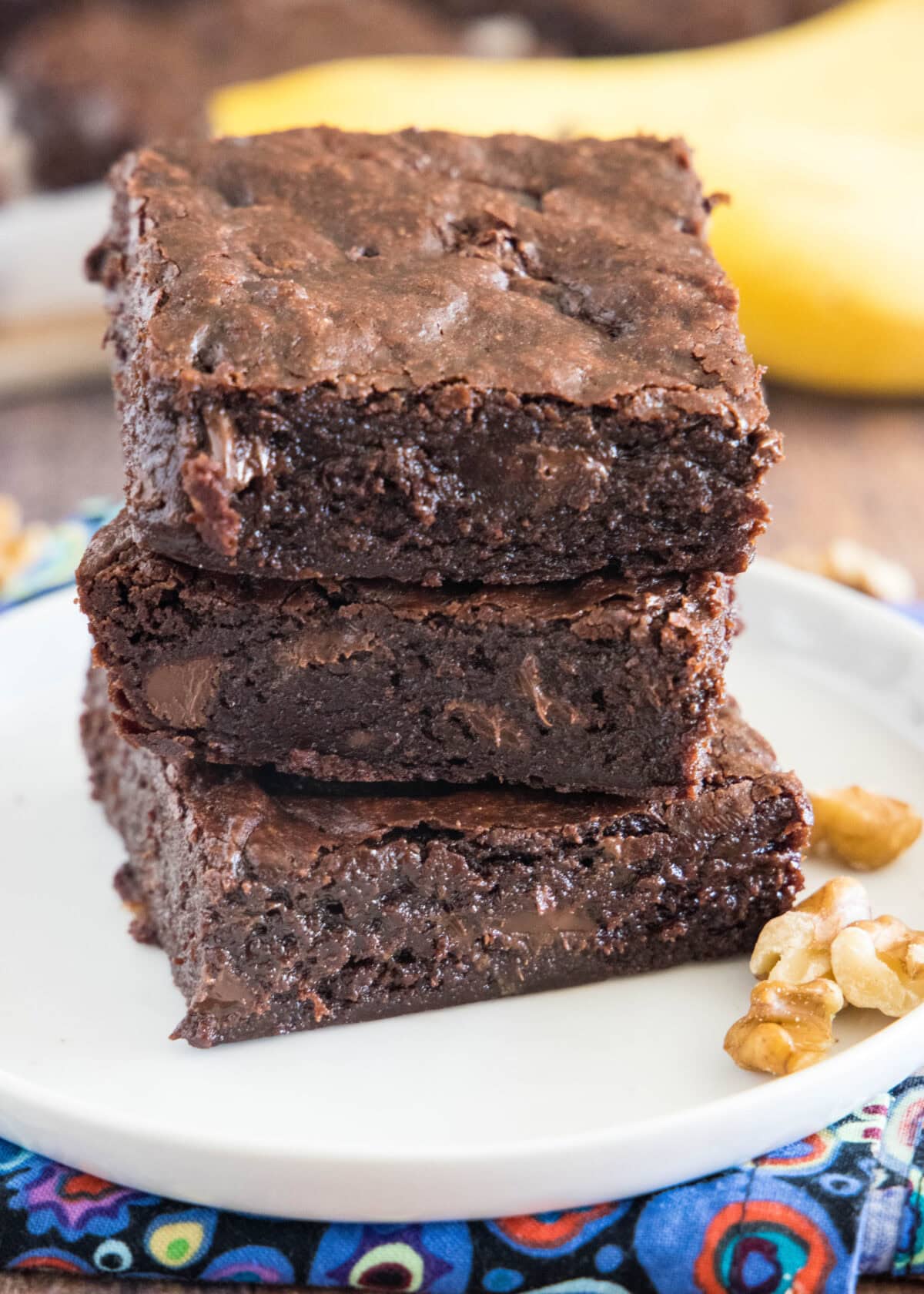 stacked fudgy banana brownies on a white plate