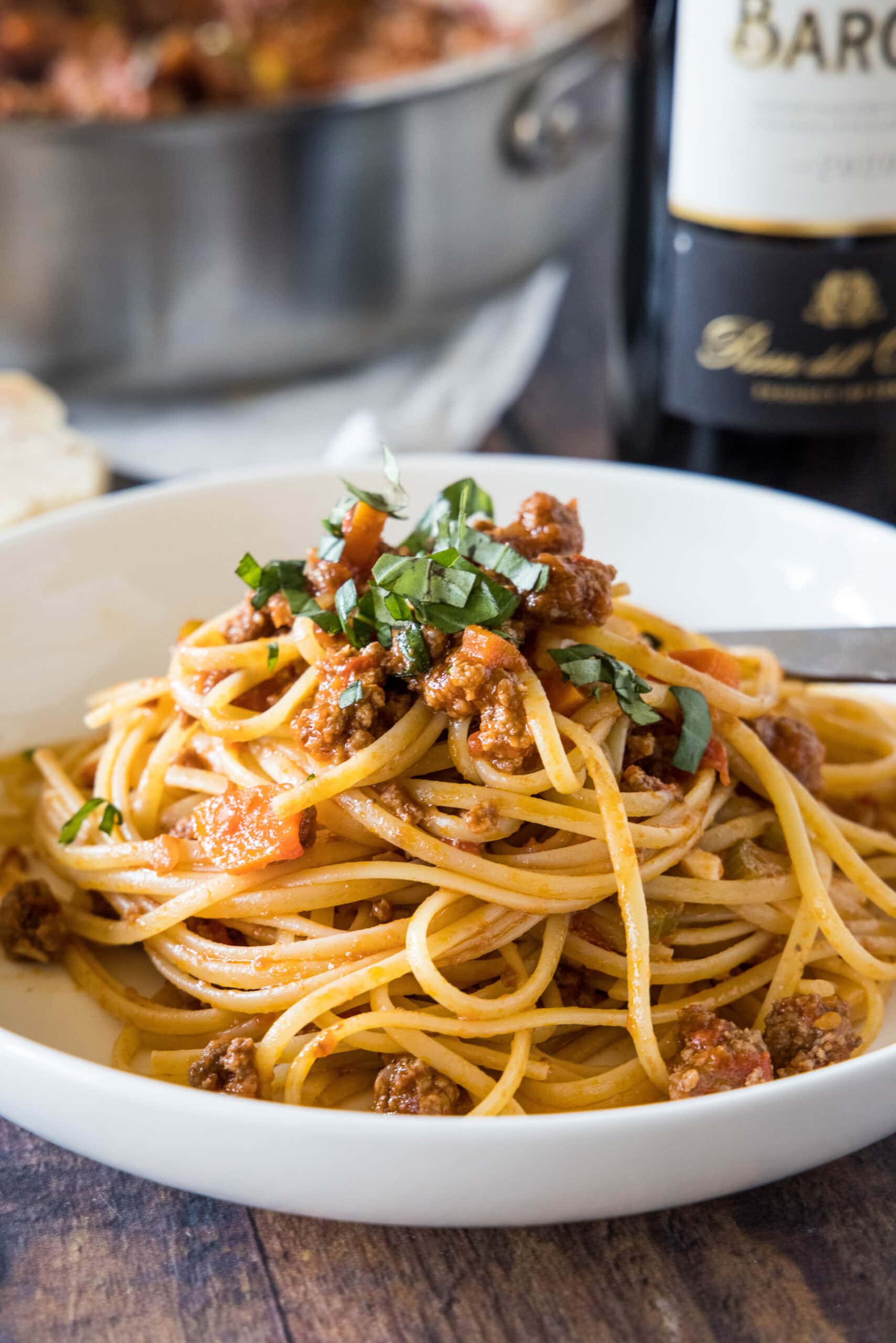 Beef ragu is an authentic Italian meat sauce with savory ground beef, juicy tomatoes, veggies, and garlic. Enjoy it over your favorite pasta! Beef ragu served with spaghetti in a white bowl.