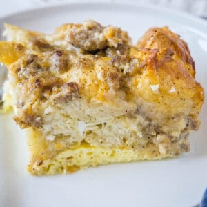 close up slice biscuits and gravy casserole on white plate