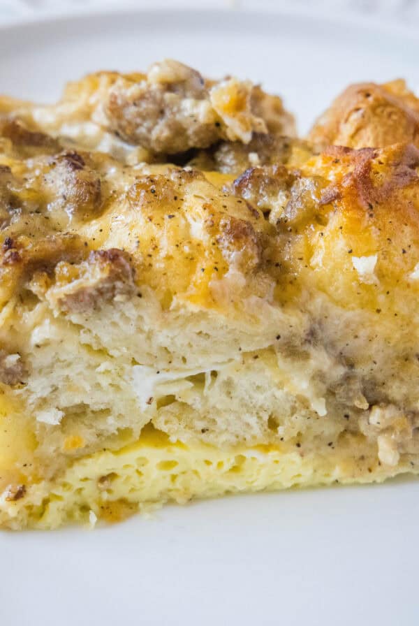 close up slice biscuits and gravy casserole on white plate