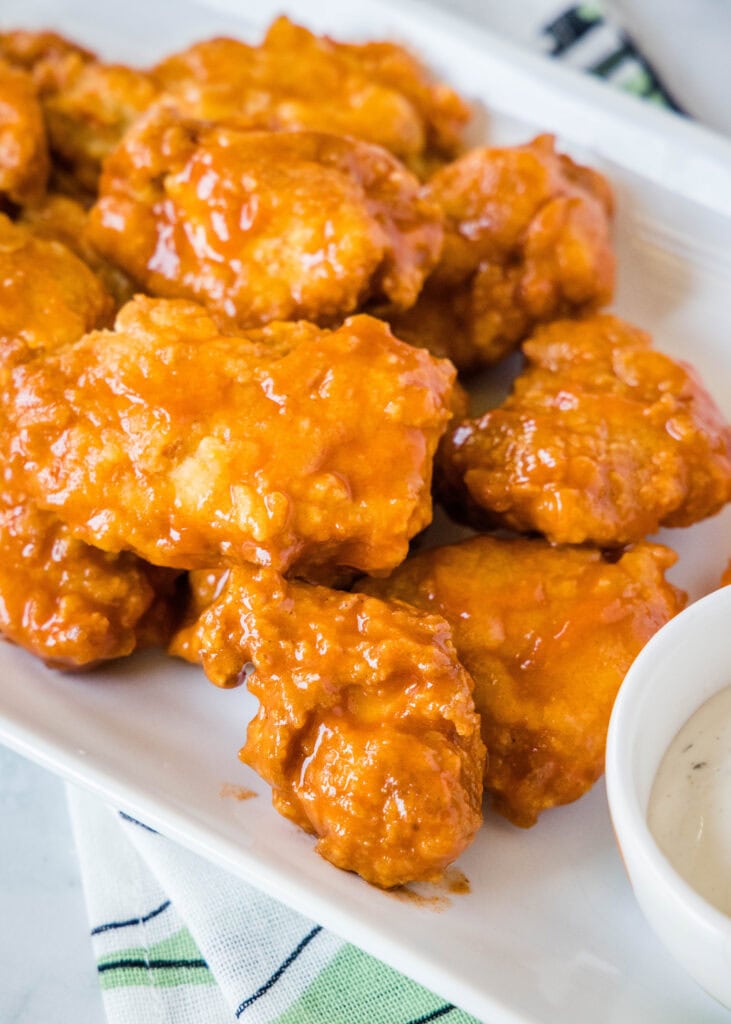 boneless chicken wings on a white plate with ranch dressing