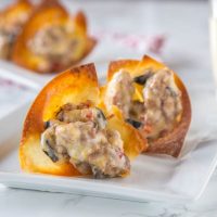 Cheesy Sausage Wonton Cups - Baked crispy wonton cups filled with a cheesy sausage mixture and baked until bubbly and hot. Great for any party, get together, or just because!