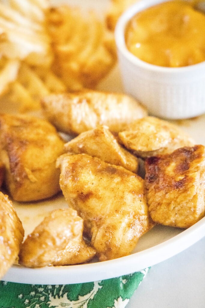 chick fil a grilled nuggets on a plate with fries