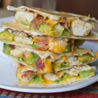 Quesadillas are a very versatile easy dinner to get on the table. This version is filled with crispy bacon, chicken, and buttery avocado. Great for busy school nights.