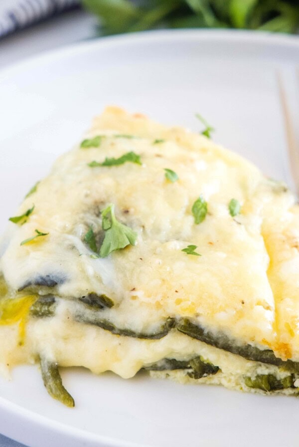 cropped close up of chili relleno casserole on a plate with a fork