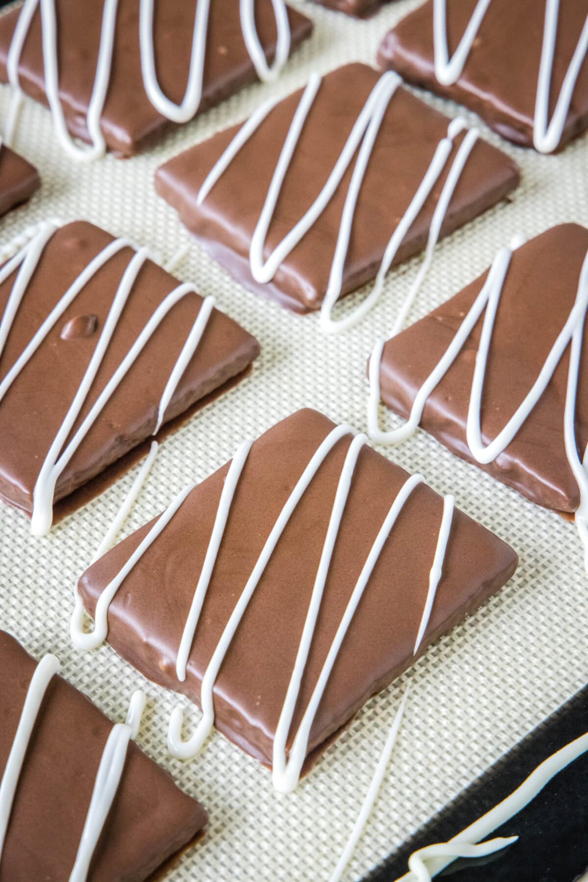 chocolate covered graham crackers setting up on a tray