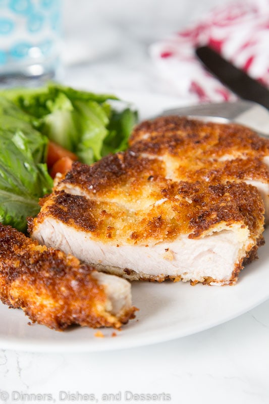 Crispy Pork Cutlet - tender boneless pork chops breaded and pan fried to crispy perfection. Served with a salad for a delicious meal any night of the week.