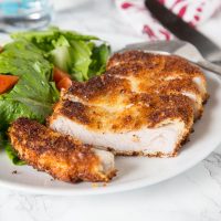 Crispy Pork Cutlet - tender boneless pork chops breaded and pan fried to crispy perfection. Served with a salad for a delicious meal any night of the week.