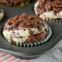 Double Chocolate Cheesecake Muffins - Rich, chocolate muffins with a layer of sweetened cream cheese for a light and tender breakfast or even dessert.