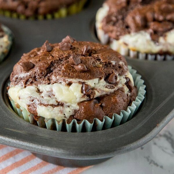 Double Chocolate Cheesecake Muffins - Rich, chocolate muffins with a layer of sweetened cream cheese for a light and tender breakfast or even dessert.