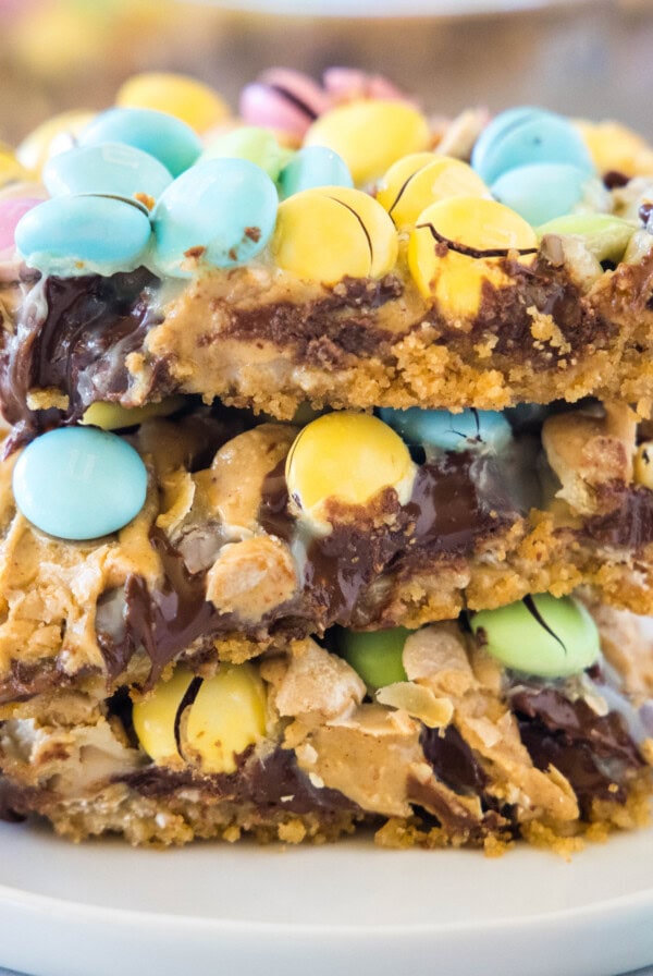 cropped close up of easter magic bars stacked on a white plate