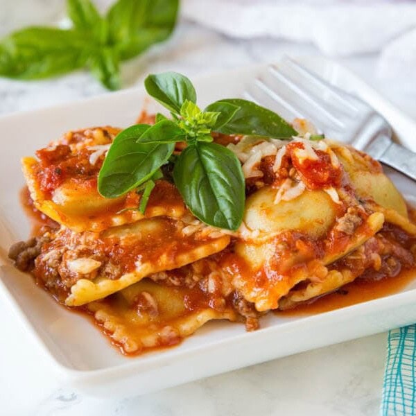baked ravioli with basil on a plate