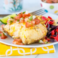 A plate of food on a table, with chicken and Lime