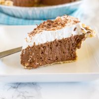 French Silk Pie - a rich and creamy chocolate pie with a layer of silky chocolate mousse topped with fresh whipped cream and chocolate shavings!