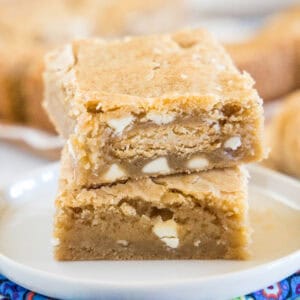 close up golden oreo blondies stacked on a white plate