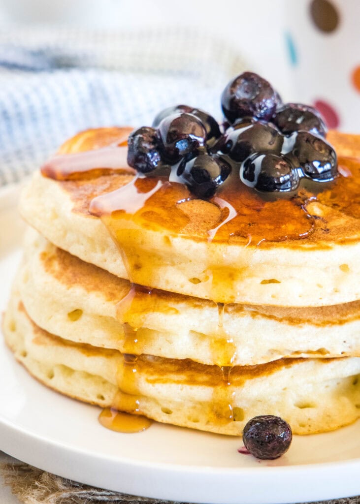 syrup over a stack of pancakes