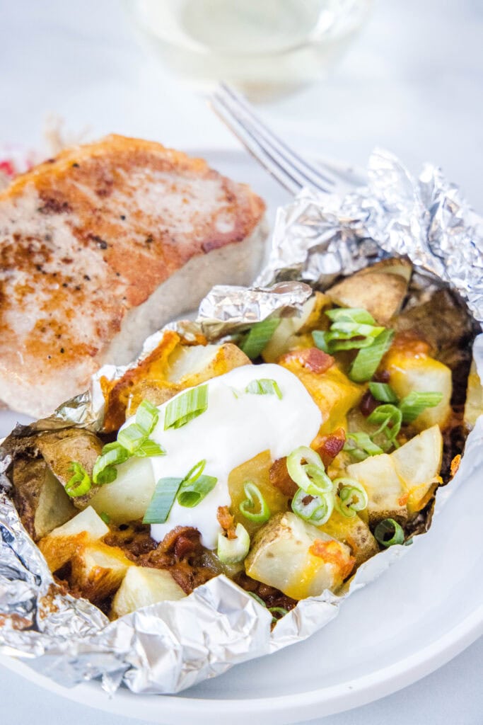 grilled potatoes in foil pack on a plate