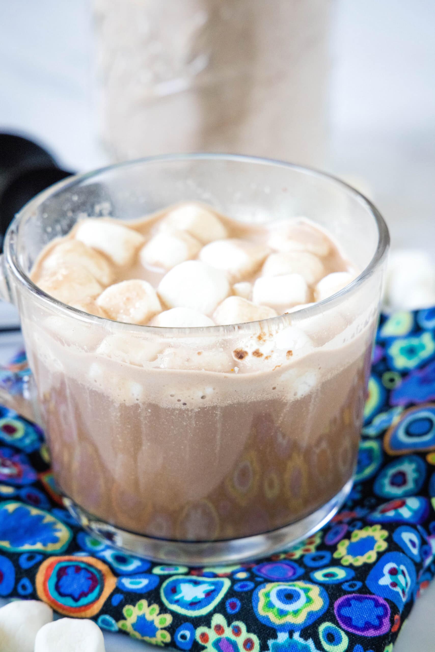 This is the best homemade hot chocolate mix with only 4 ingredients! It keeps in the pantry for months and makes the creamiest hot cocoa. Hot chocolate in a clear mug topped with mini marshmallows.