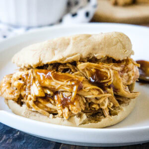 close up bbq chicken sandwich on a plate