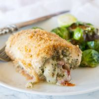 Italian Stuffed Chicken - chicken breasts rolled up with pesto, tomatoes, and cheese! Then baked until crispy and delicious, a great family dinner.