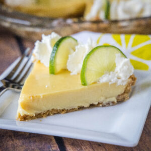 close up key lime pie slice on a white plate