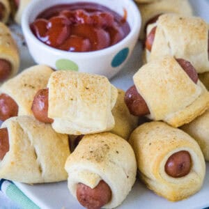 cropped close up mini pigs in a blanket on a plate