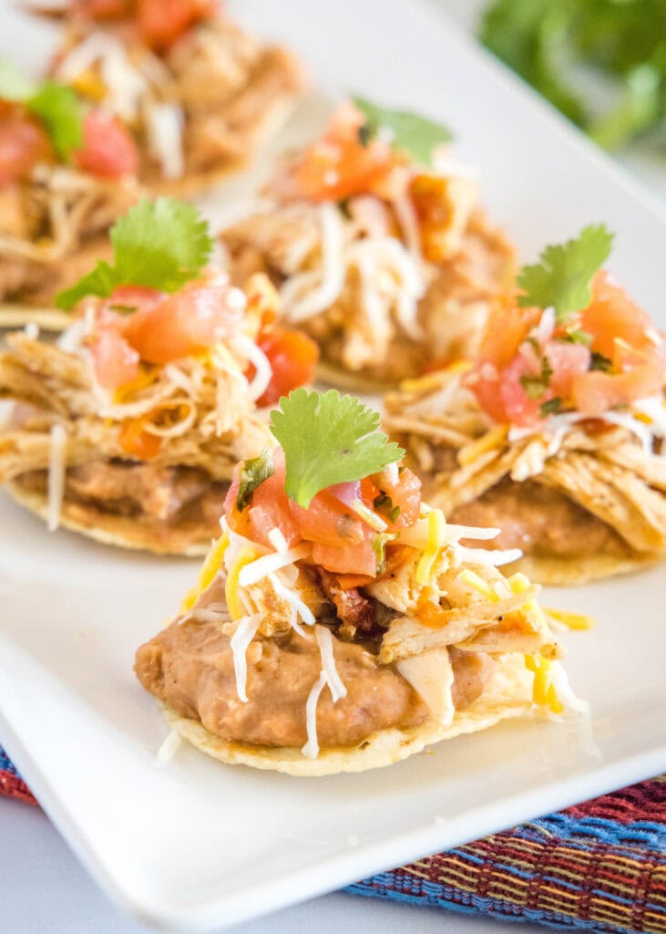a plate with mini bean tostadas