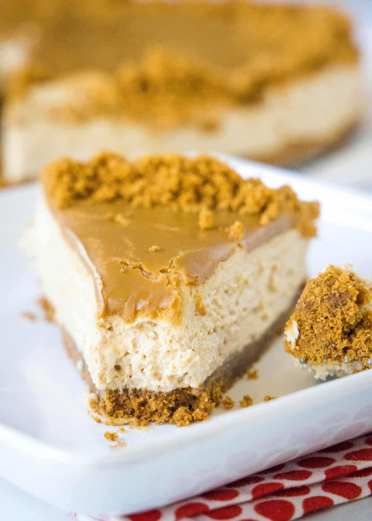 a slice of biscoff cheesecake with a bite missing