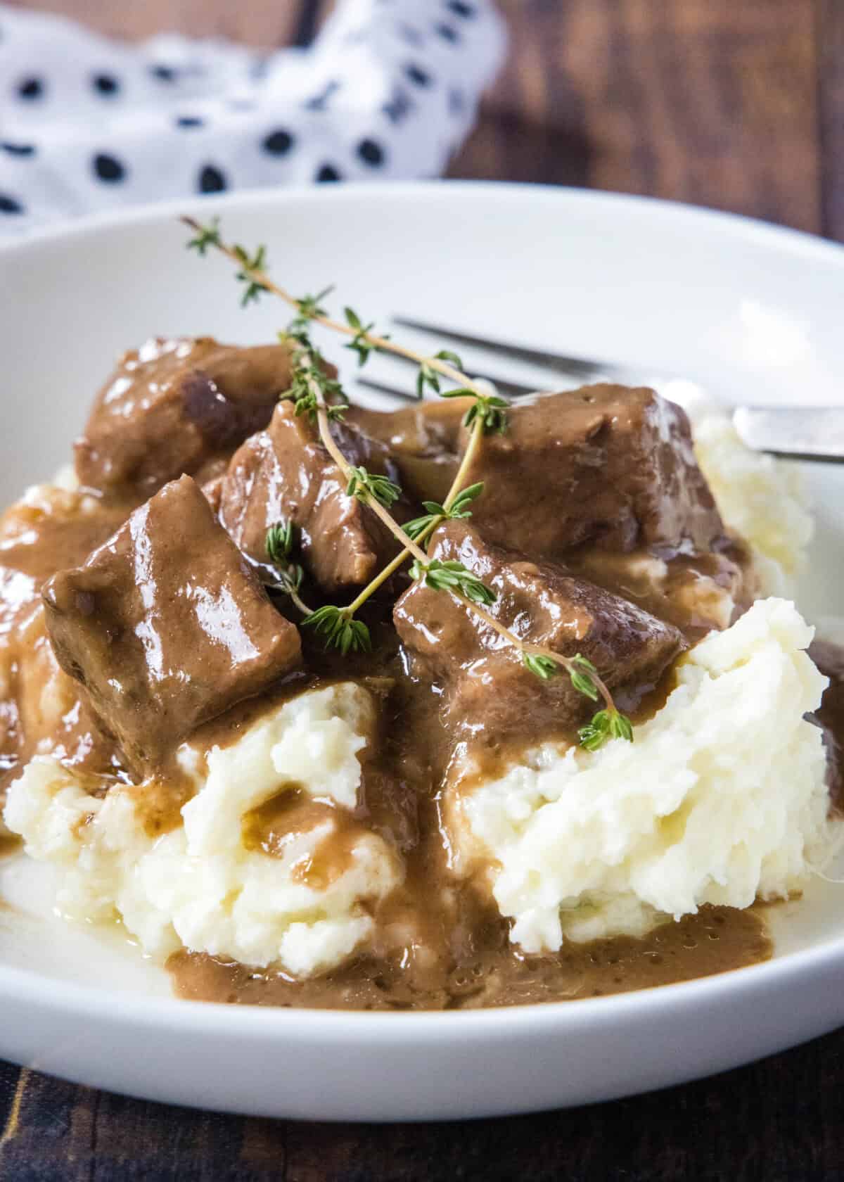 beef tips in gravy over mashed potatoes