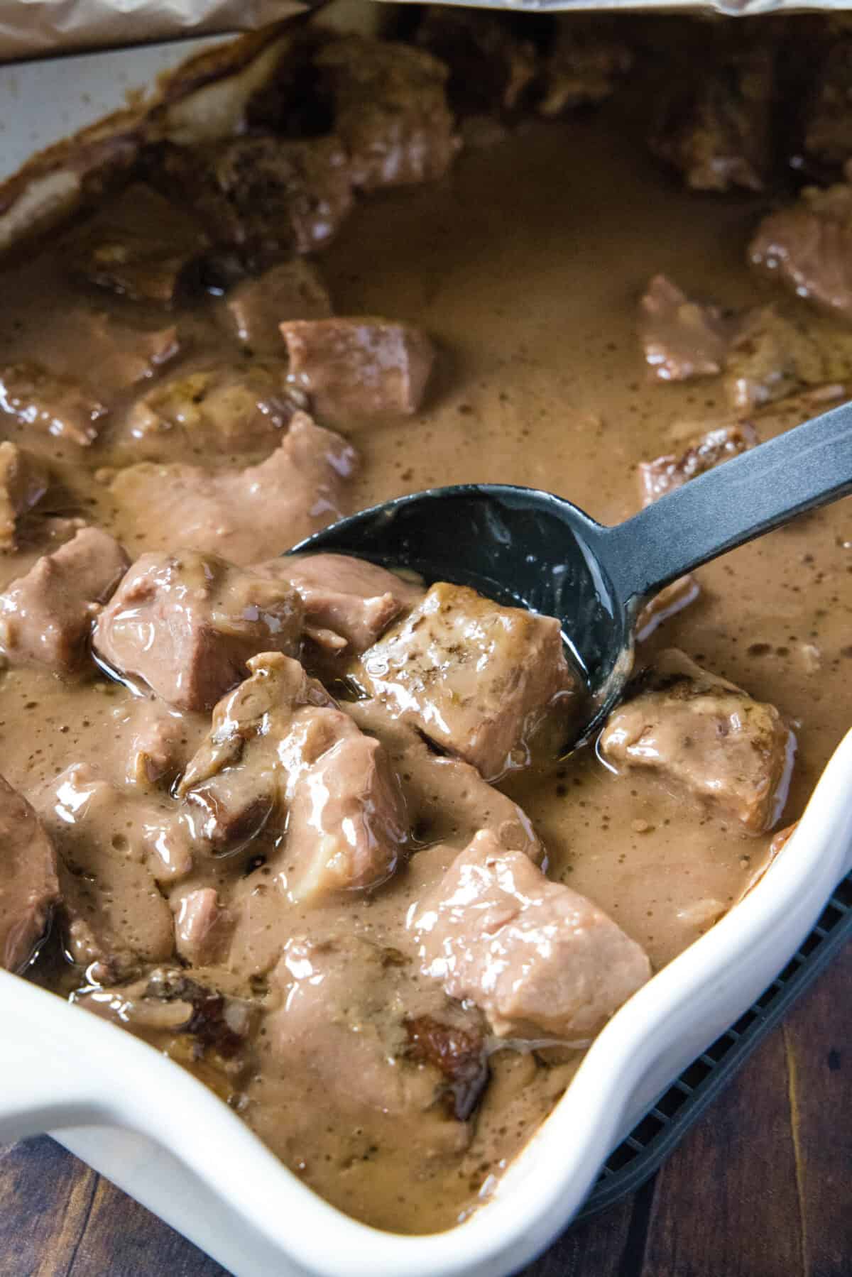 scooping no peak beef tips out of casserole dish