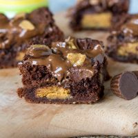 Peanut Butter Stuffed Brownies - rich, fudge brownies that are stuffed with peanut butter cups, topped with melted chocolate and more peanut butter cups!