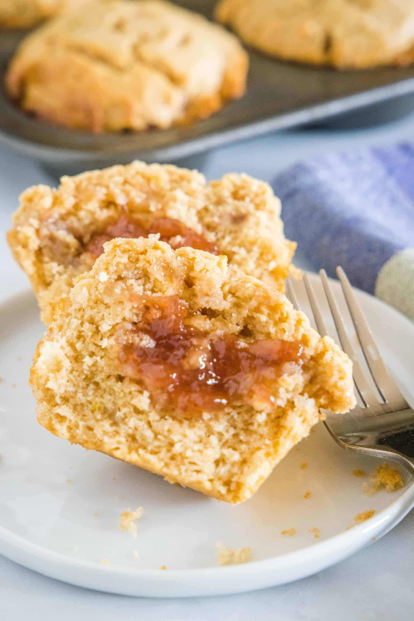 peanut butter and jelly muffin cut in half on a plate