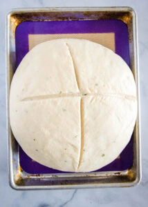 potato bread with x mark on top ready for the oven