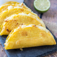close up of crispy potato tacos on a tray