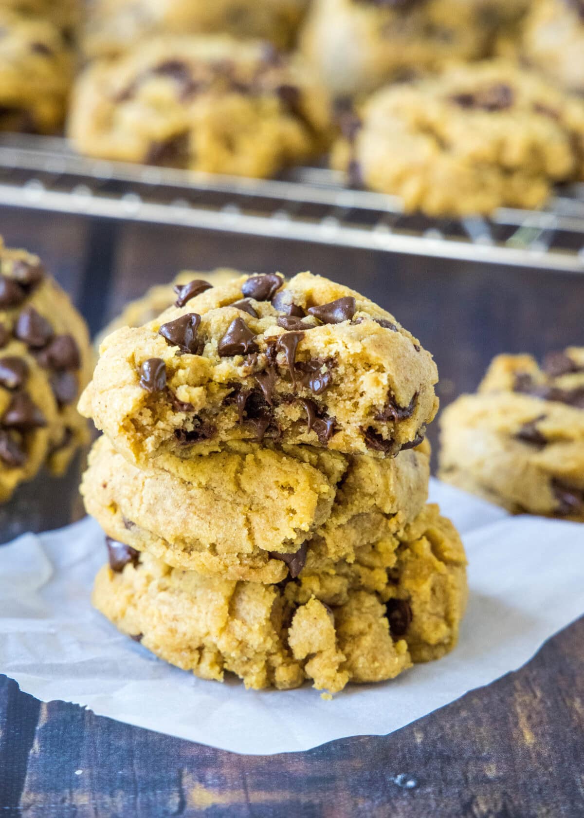 stack of chewy pumpkin chocolate chip cookies with a bite missing from one