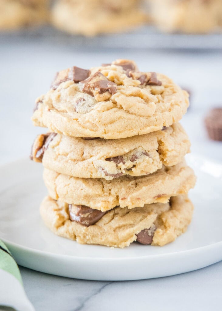 stacked reese's peanut butter cookies on a plate