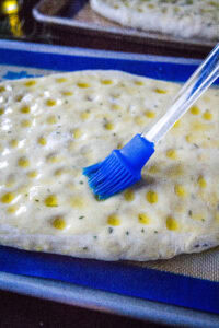 brushing oil on bread dough