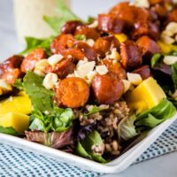 A plate full of salad with sausage