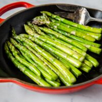 Sauteed Asparagus - super simple side dish with asparagus sauteed in butter, garlic and seasoned with salt and pepper. Ready in just minutes, healthy, and goes with just about everything.