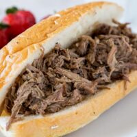Slow Cooker Italian Beef - use your crock pot to make these super tender Italian Beef Sandwiches. Cooks all day in great spices, for a tender and flavorful dinner.