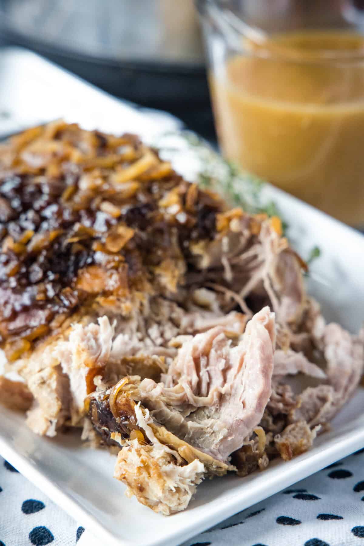 pork roast from crock pot on a white plate