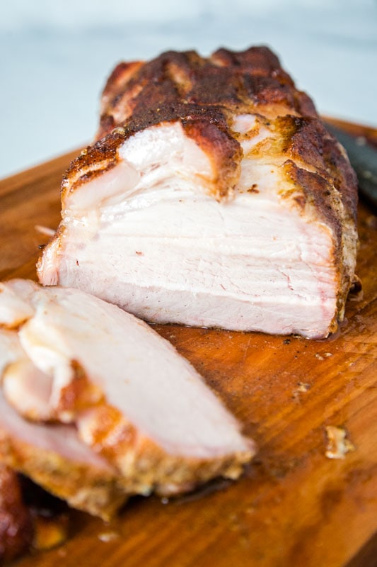 pork loin roast cut in half on cutting board
