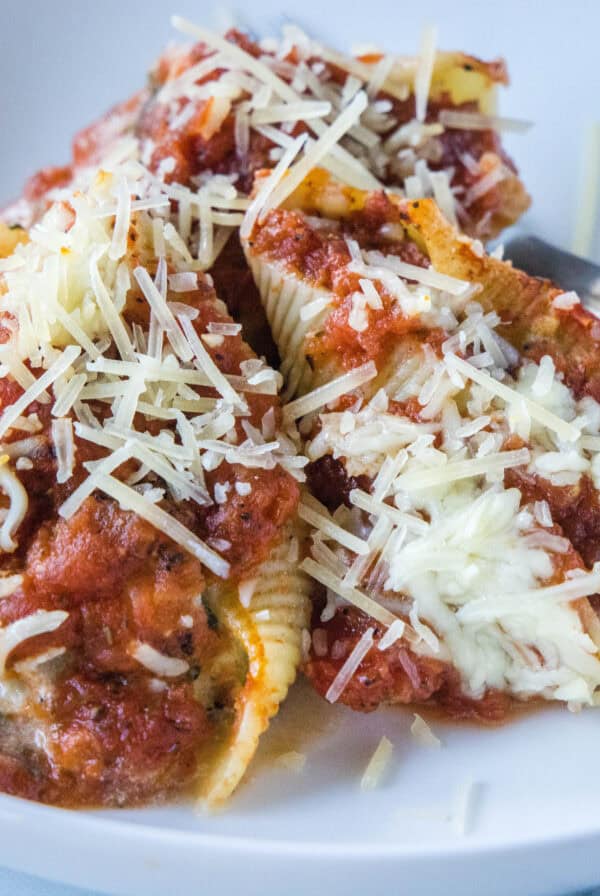 cropped close up spinach stuffed shells on a white plate