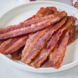 cropped close up cooked turkey bacon on a white plate