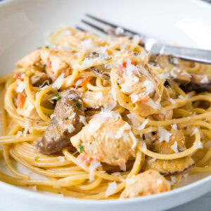 close up tuscan chicken skillet on a white plate